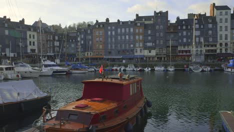 moorings at the old harbour or vieux bassin with waterfront townhouses at honfleur in normandy, france