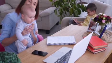 mom and children with laptop working from home