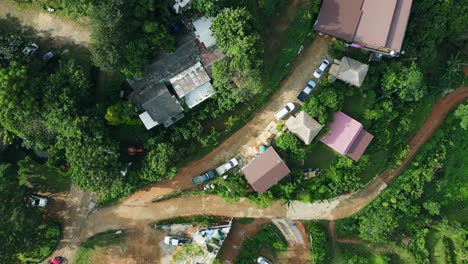 Aerial-view-of-sky-road-over-top-of-mountain-with-fog-and-green-jungle-in-morning-Nan,-Thailand