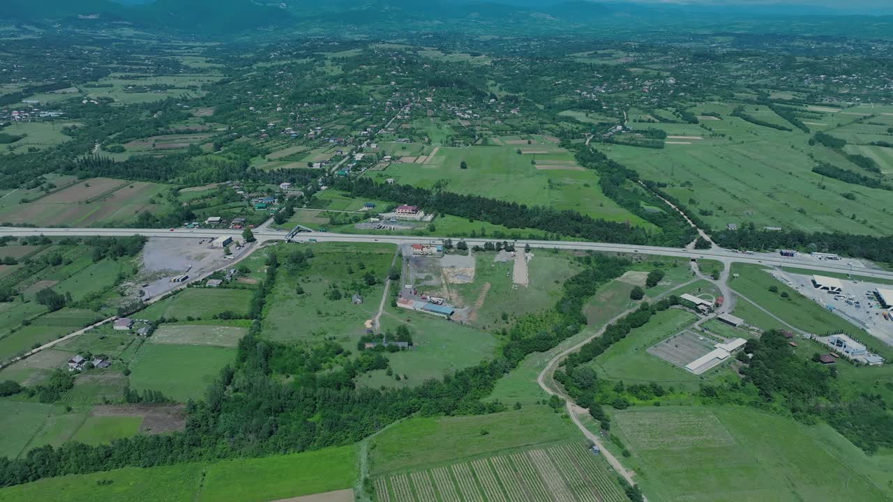 Aerial view of rolling hills and fields in a rural area, showcasing the scenic beauty and agricultural land use