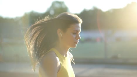 woman jogging on outdoor track in sportswear at athletic field