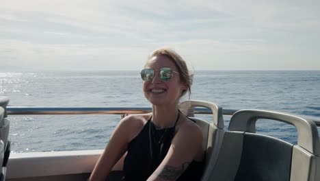 Female-Tourist-Wearing-Sunglasses-While-Cruising-On-Boat-In-Italy