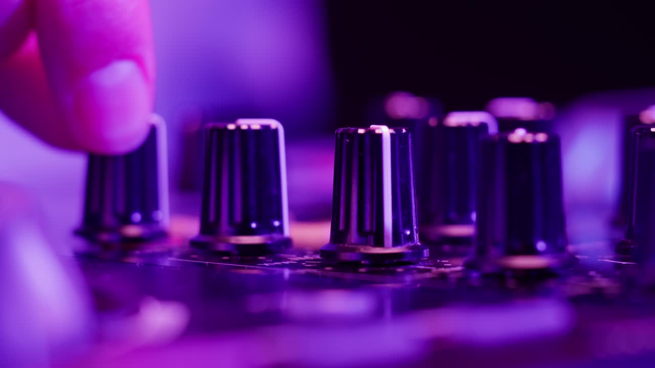 DJ with headphones and sunglasses playing music on festival in night club. Techno musician performing at nightclub for concert crowd of people, city bar.