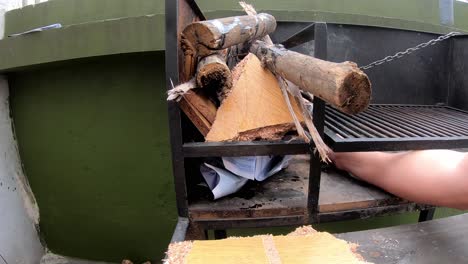 slow motion video of a man turning on the grill to make roast, a sunny day