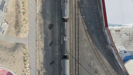 a black tank car on the railroad transporting petroleum and gaseous commodities in a power plant in wenatchee, washington