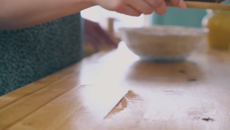 woman-takes-board-with-cups-and-teapot-from-table-close-view