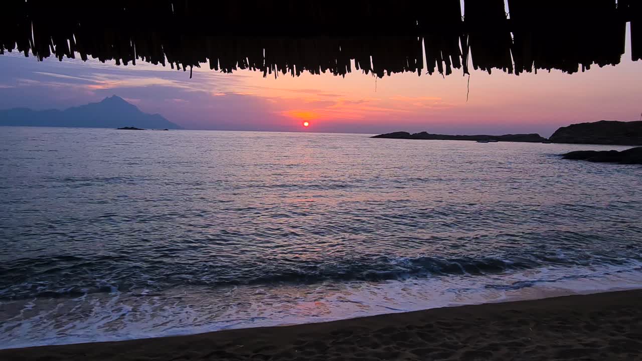 Sunrise Above Sea and Waves Breaking on Sandy Beach