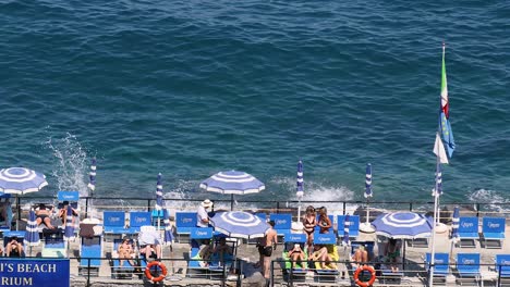 people relaxing by the sea in sorrento