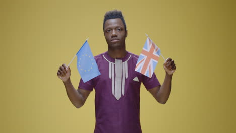 man proudly waving flags