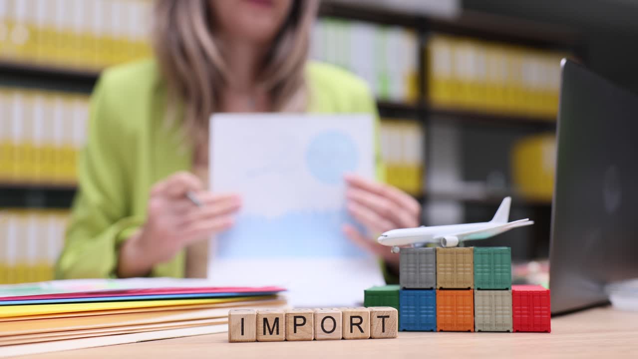 Import and global logistics concept with miniature containers, airplane, and a person working