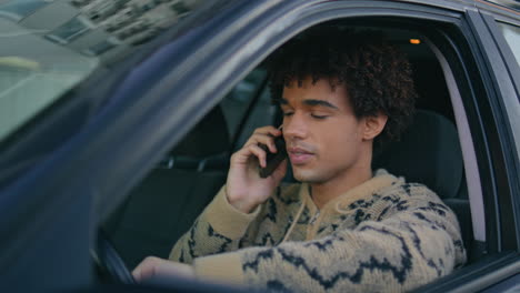 driver enjoy phone call in car ready to drive closeup. latino hipster mobile