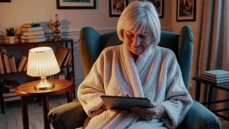 elderly woman using tablet at home