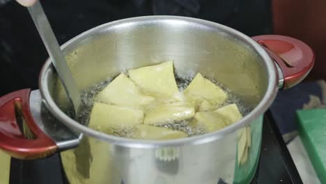 italian chef cooks panella sicilian fritters made of chickpea flour closeup kitchen shot