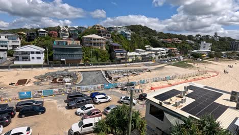 construction site with parked cars and buildings