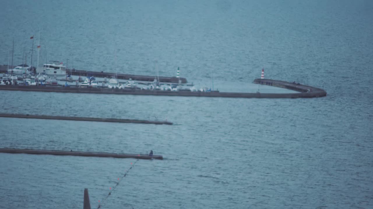Panning shot of a coastline towards the city