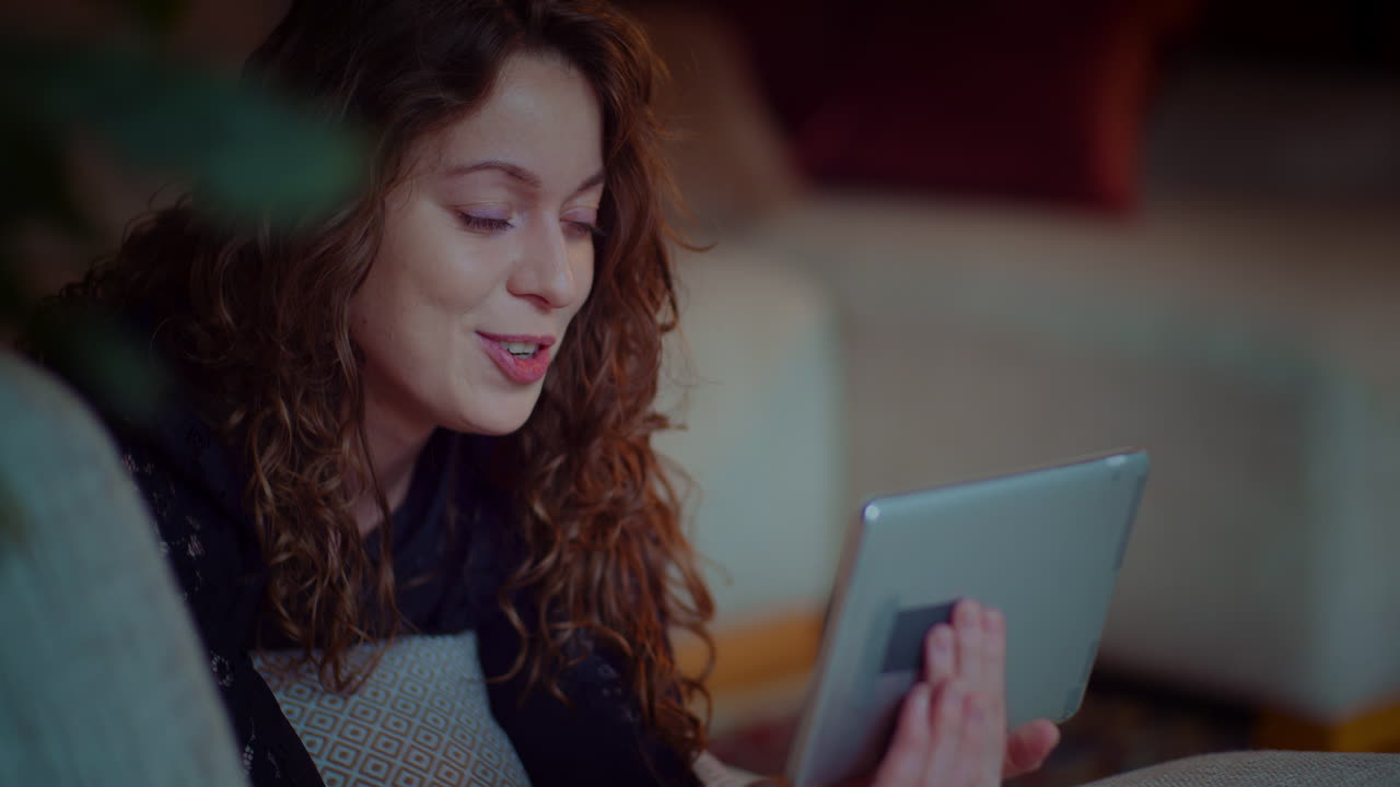 Woman using a tablet on a couch