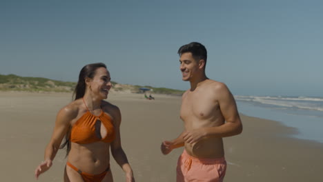 cute couple running at the beach