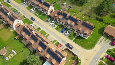 Looking-down,-panel-rooftop-one-the-leading-renewable,-solar-panels-energy-Efficiency-neighborhood-suburb-is-covered-in-rooftop-solar-energy