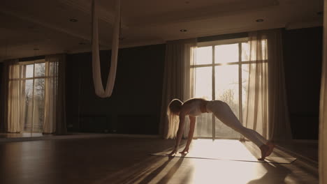 healthy woman exercising at home practicing yoga poses in room enjoying morning fitness workout