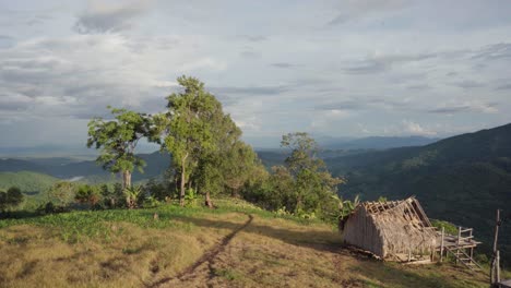 4k hd cinematic view sunlit mountains with a bamboo hut in the foreground in mae tang, thailand
