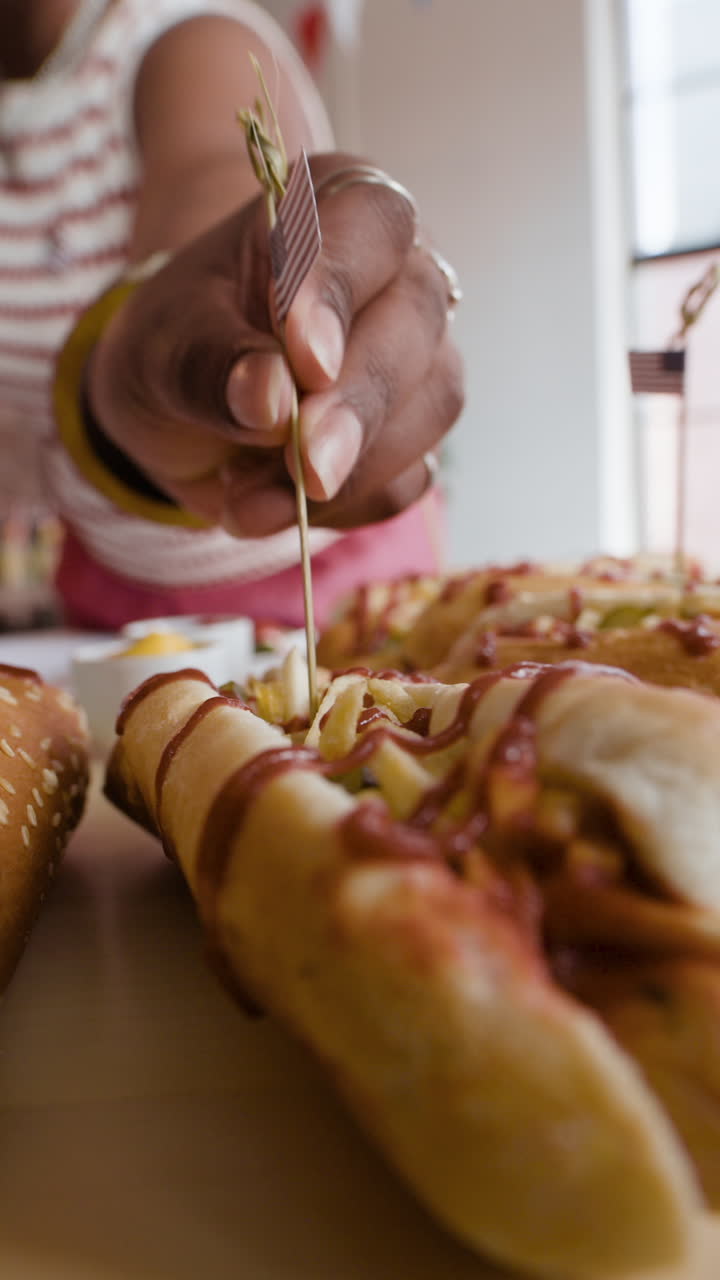 Woman Serving Hot Dogs with American Flag Toppings