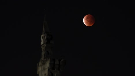 blood moon over a tower