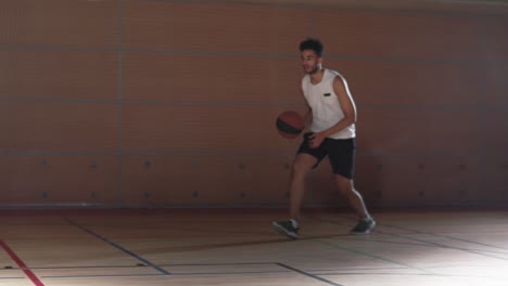 young man player puts basket on the basketball court