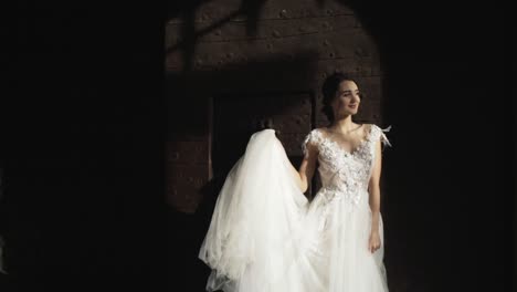 bride in a wedding dress posing in front of a historical door