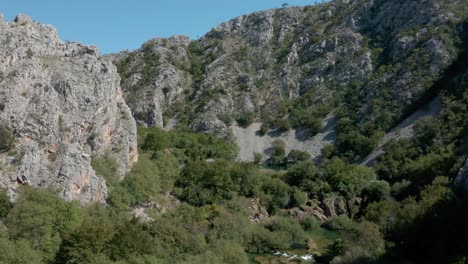 aerial view flying low through zrmanja river canyon wilderness landscape valley, croatia