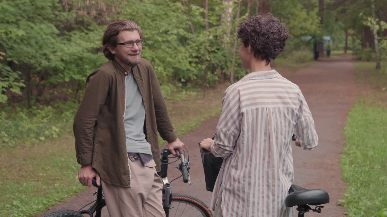 Chatting Couple In Forest With Bikes