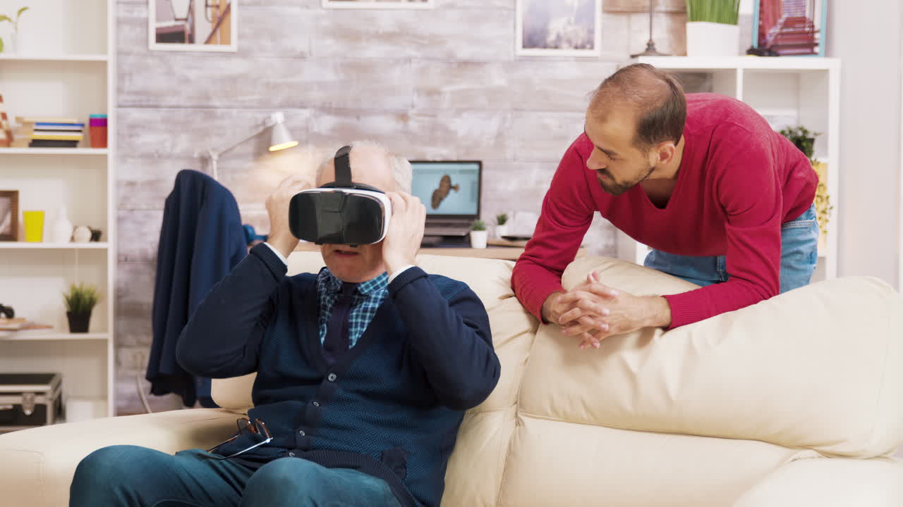 Senior man experiencing virtual reality with his son