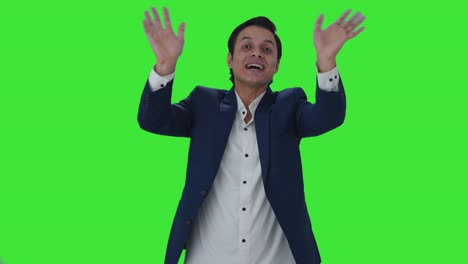 Happy-Indian-journalist-saying-hello-Green-screen