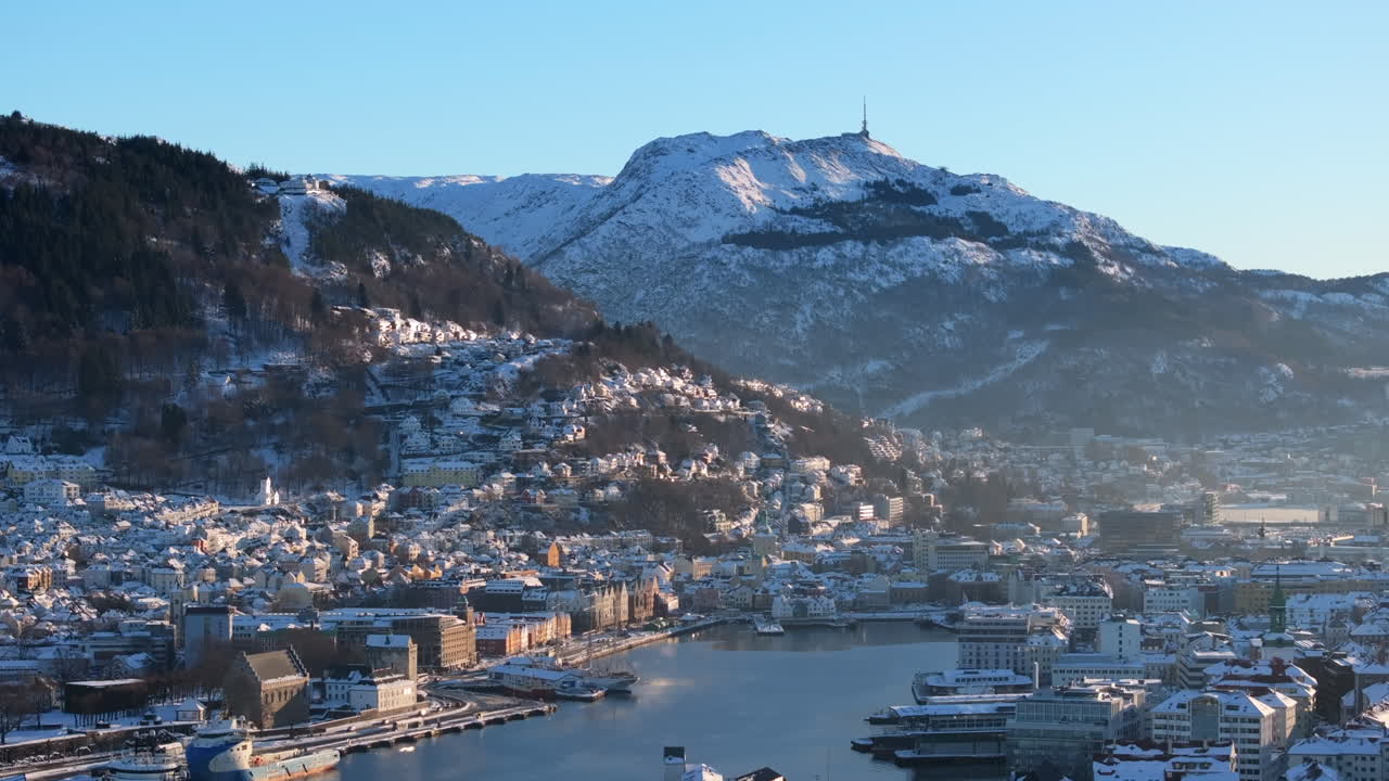 Beautiful winter day in Bergen with snow on Bryggen, the mountains and the old houses in the city center