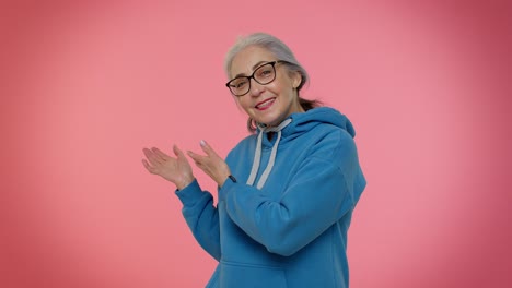 elderly senior granny woman showing inviting gesture with hands, ask to join, beckoning to coming