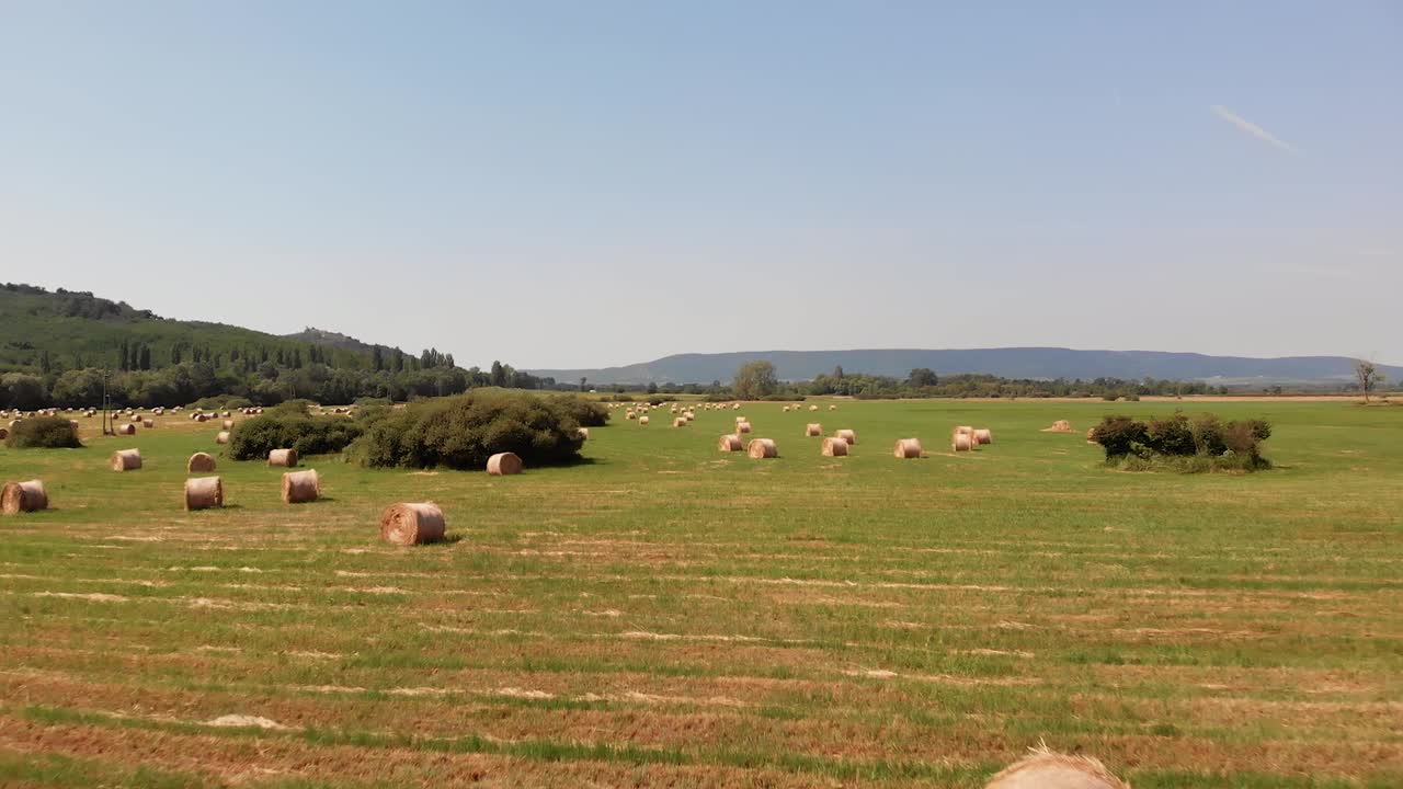 Aerial drone footage, hay bales on the meadow in Hungary