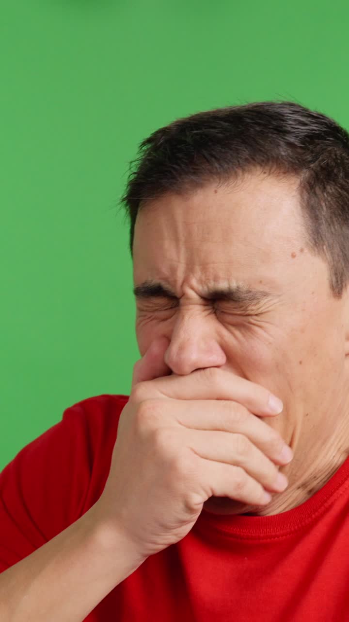 Man gets bored watching tv and starts using his phone