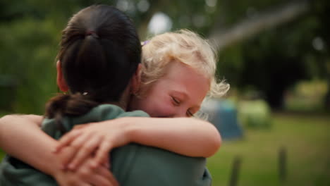 mother, child and hug at a park outdoor in nature