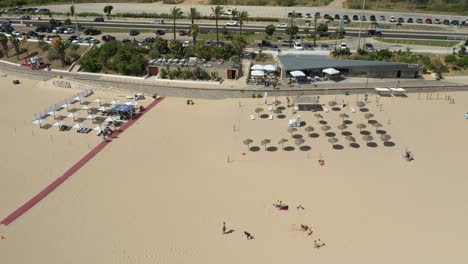 aerial drone video of the restaurants, bars and umbrellas in carcavelos beach, lisbon, portugal