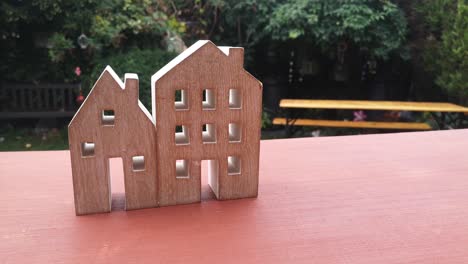 Tiny-wooden-house-ornament-in-residential-garden-property-mortgage-concept-idea