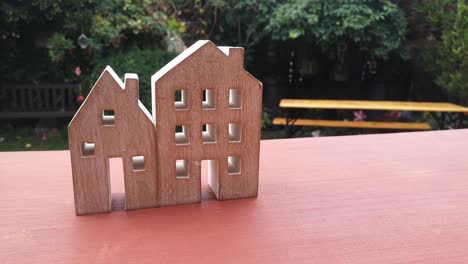 tiny wooden house ornament in residential garden property mortgage concept idea