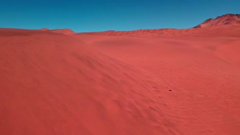 aerial view of red desert dunes, sunny day in atacama, chile