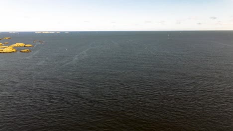 Flying-over-the-ocean-panning-over-to-islands-on-a-beautiful-summer-day