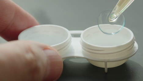 putting a contact lens into a case