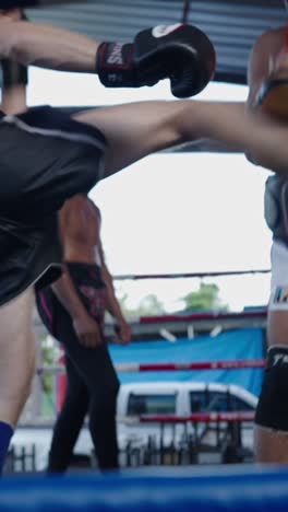 muay thai fighters sparring in the ring