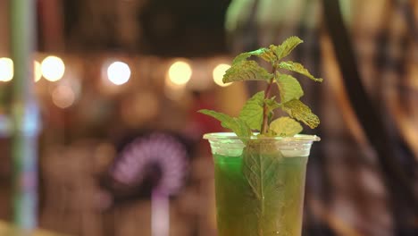 alcohol beverage with mint leaves on blurred background