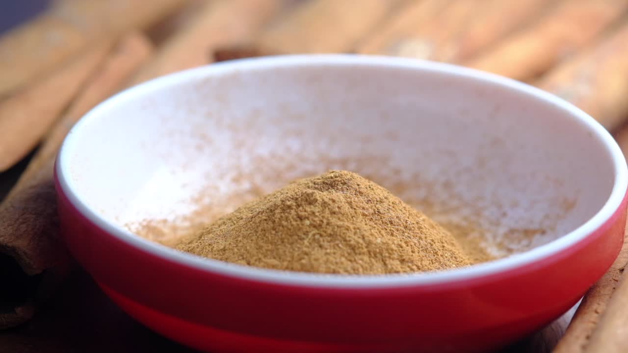 Cinnamon Powder Being Poured into a Bowl