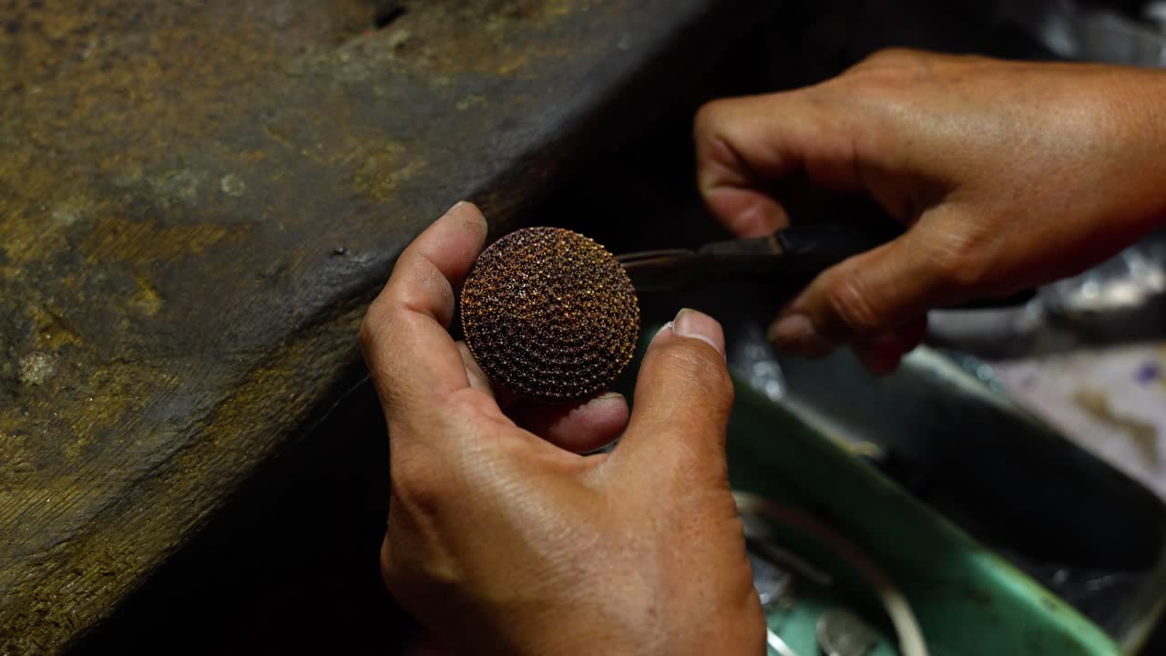 Silversmith crafting jewelry in Bali's Celuk Village, focused and skilled