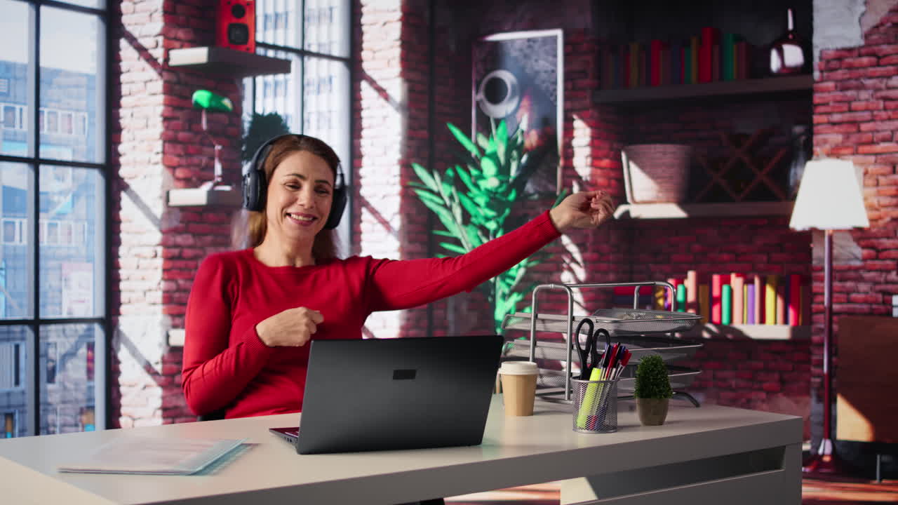 Woman Dancing to Music at Her Desk