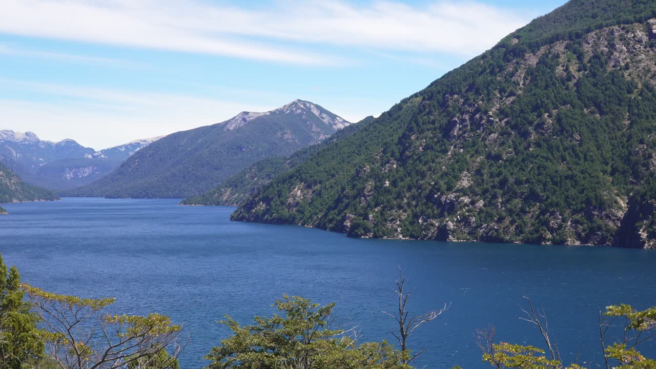 Zoom-In View of Brazo de la Tristeza in Bariloche with blue waters, forested slopes and Andean peaks in Nahuel Huapi National Park, Argentina