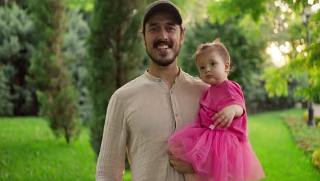 a happy father and daughter in a park.